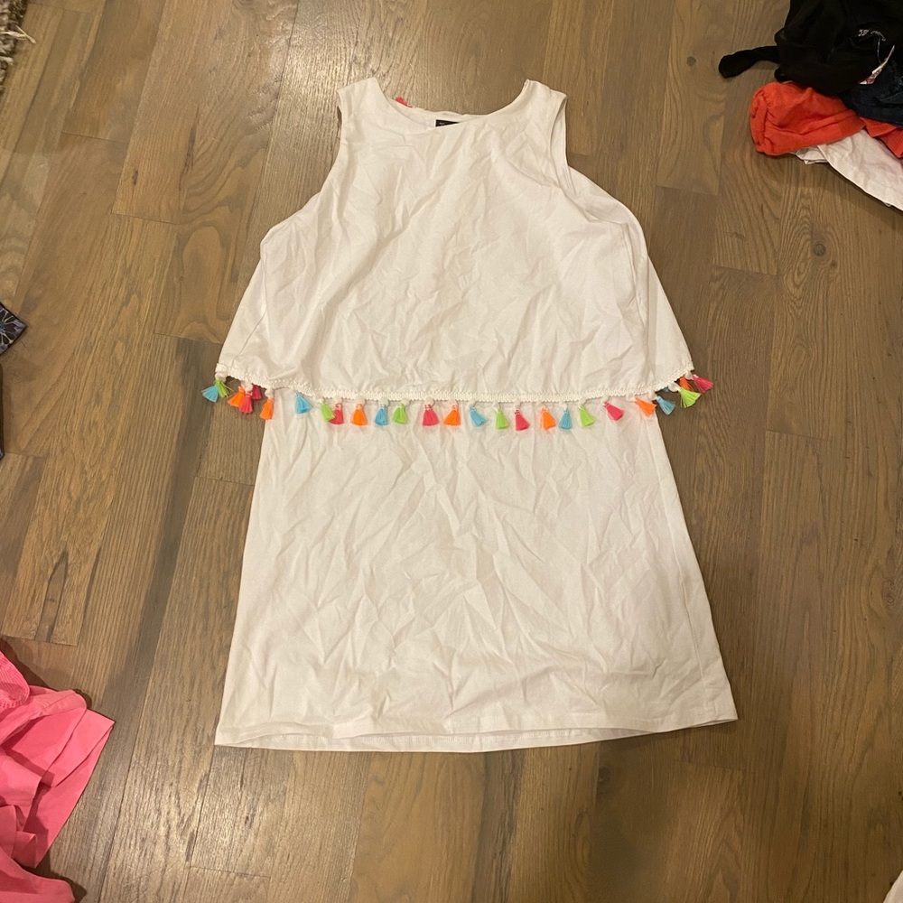 white dress with pom poms